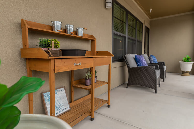 A cozy patio setup with a wooden cart and comfortable seating.