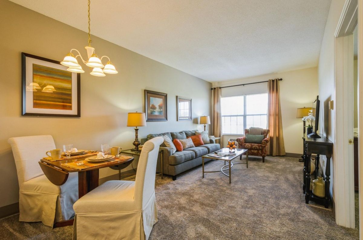 A cozy living room and dining area with comfortable furnishings and warm lighting.