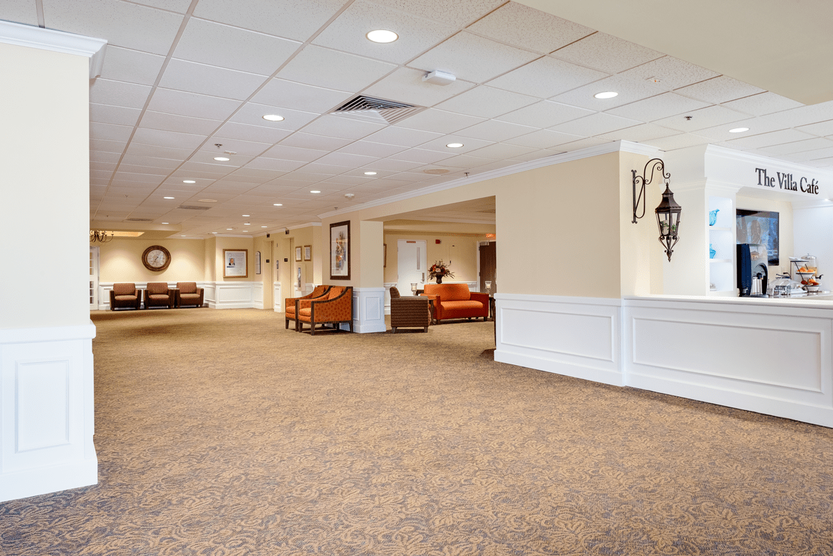 A spacious lobby interior with carpet flooring and comfortable seating areas.