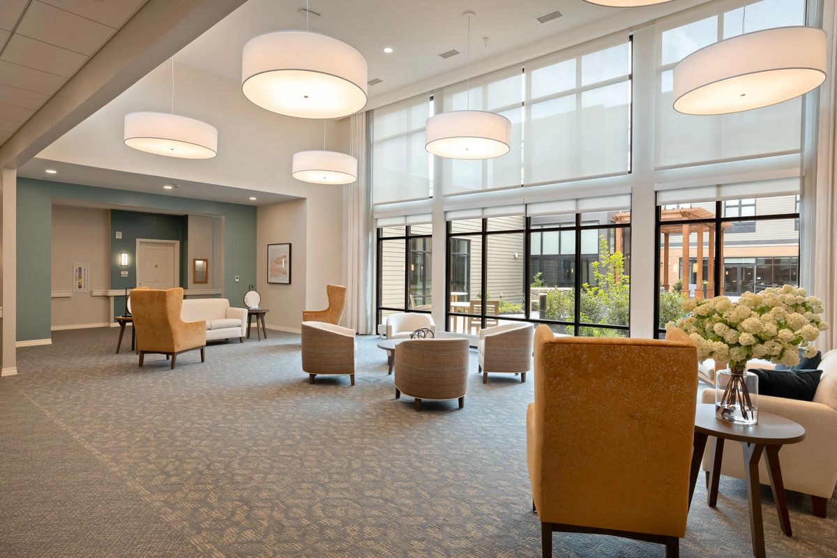 A modern and spacious lobby with comfortable seating and large windows.