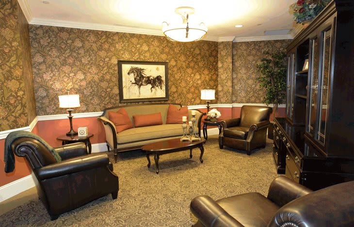 A cozy living room with elegant furniture and warm lighting.