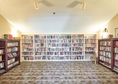 A well-organized library with rows of bookshelves filled with books.