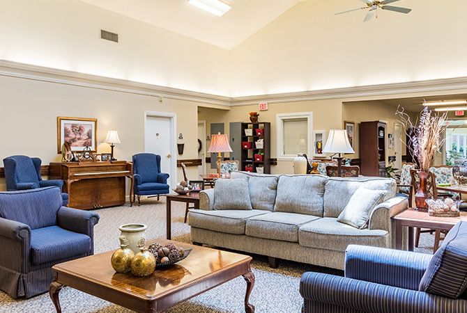A spacious and well-lit living room with a comfortable sofa and elegant decor.