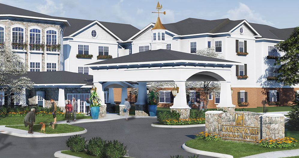 A beautifully designed residential building with a landscaped entrance and clear sky.