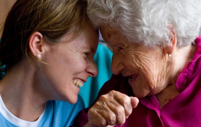 An elderly woman and a younger person share a joyful moment, symbolizing warmth and connection.
