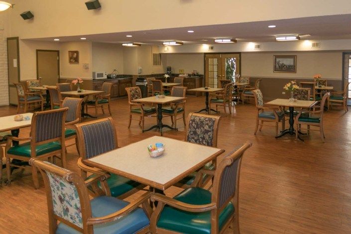 An empty dining area with neatly arranged tables and chairs.