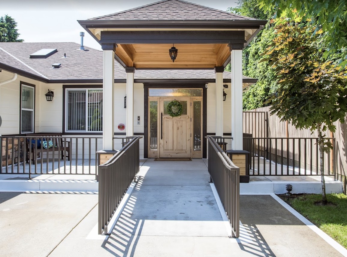 Front entrance of a residential house featuring a ramp and covered porch.