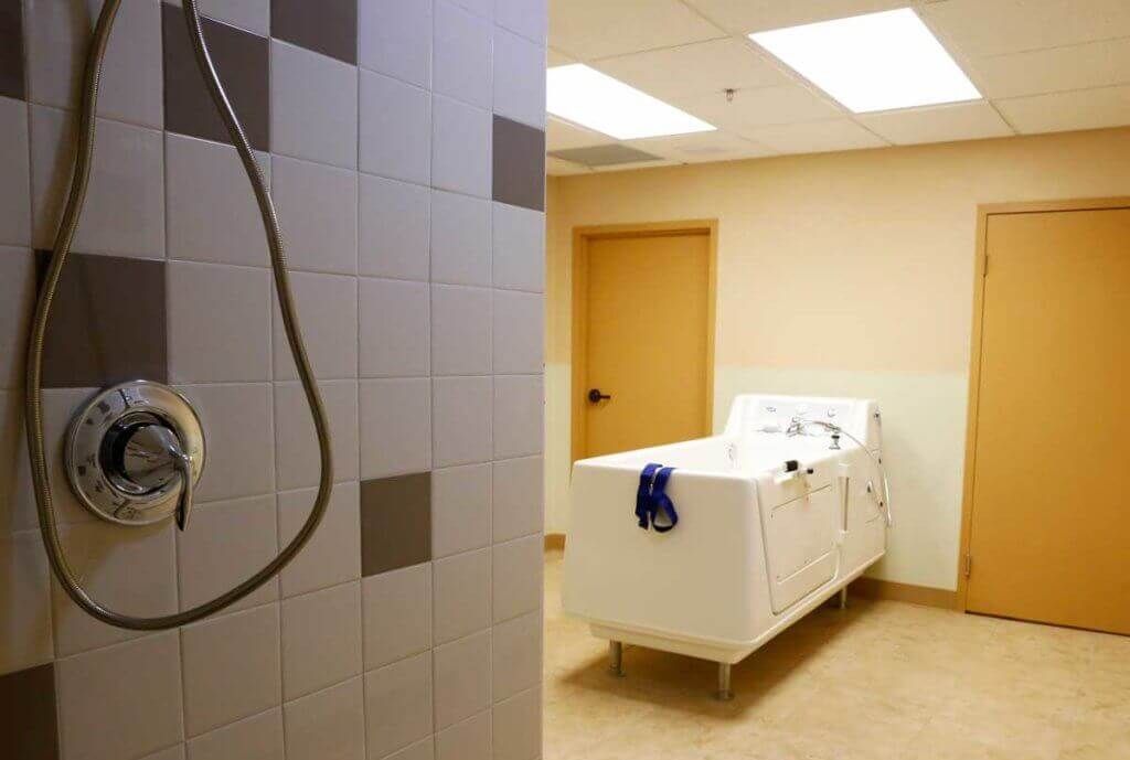 A clean and modern bathroom with a shower and bathtub.