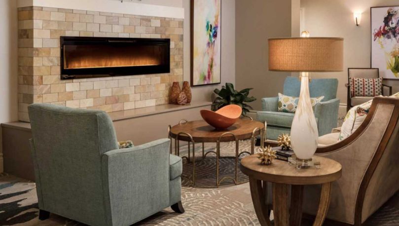 A cozy and modern living room featuring comfortable seating, a warm fireplace, and tasteful decor.