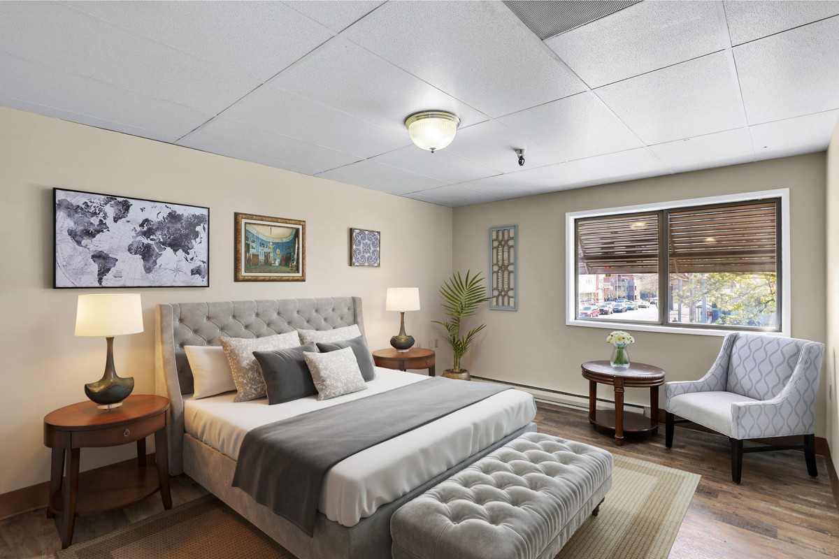 A modern and well-lit bedroom with stylish decor and comfortable furnishings.