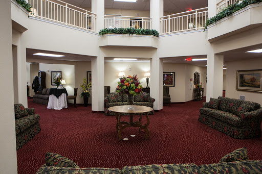 A spacious lobby with elegant seating and decorative floral arrangements.