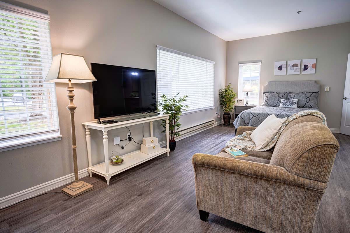 A cozy and modern living room featuring a comfortable sofa, flat-screen TV, and elegant decor.