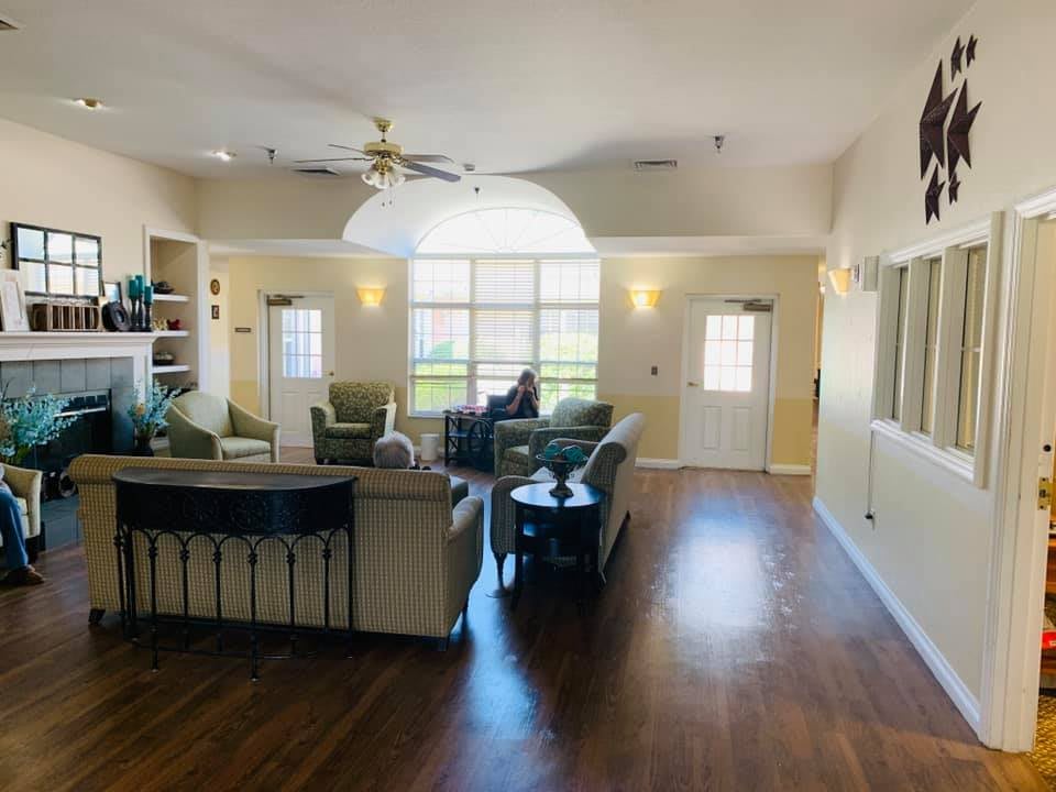 A spacious living room with modern furniture and large windows.