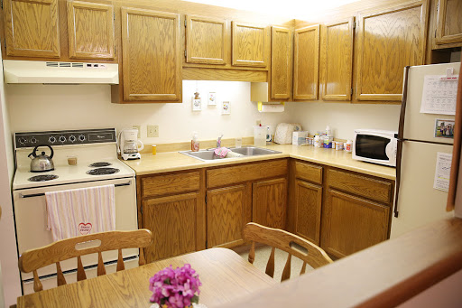 A cozy kitchen with wooden cabinets and a small dining area.