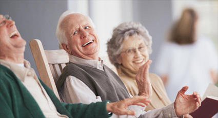 An elderly couple laughing and enjoying their time together.