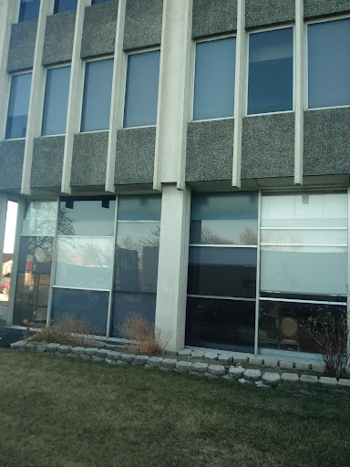 A modern building showcasing a combination of concrete and glass elements.