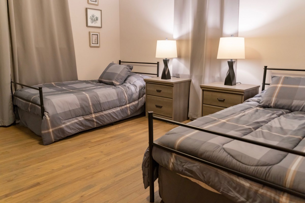 A cozy bedroom with twin beds and stylish decor.