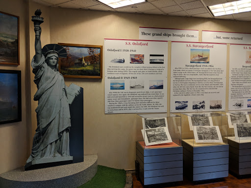 An exhibit featuring a model of the Statue of Liberty, highlighting its significance in American history and immigration.