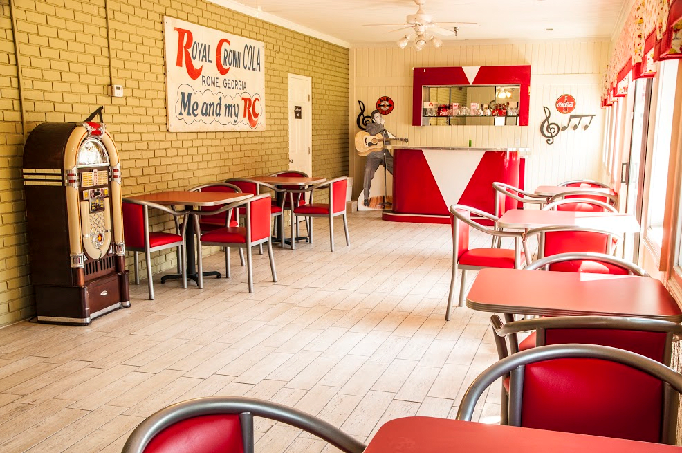 A retro diner with vintage decor and red chairs, capturing a nostalgic 1950s style atmosphere.