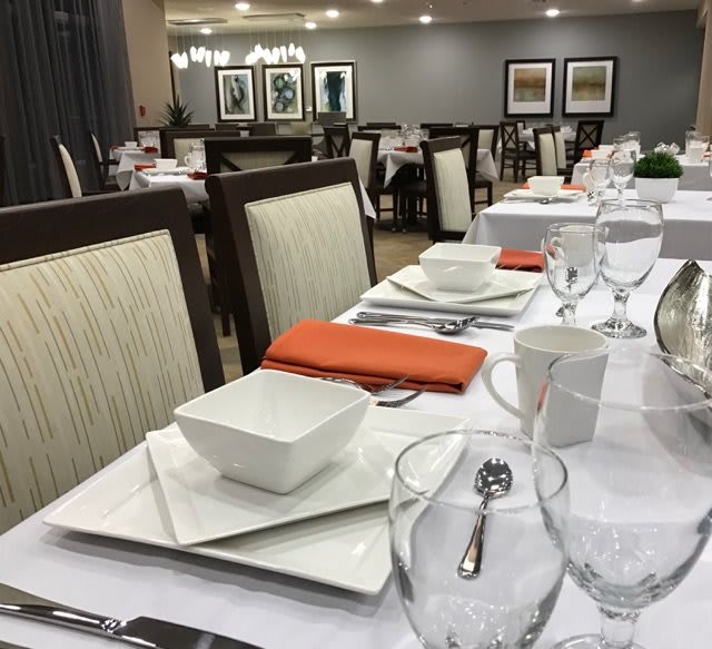A neatly arranged dining table with elegant table settings in a restaurant.
