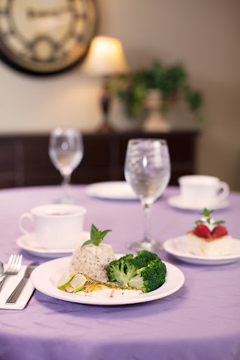 A beautifully arranged meal featuring broccoli, rice, and a refreshing dessert with strawberries.