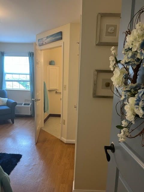 A cozy living room with a view through an open doorway, featuring home decor and furniture.