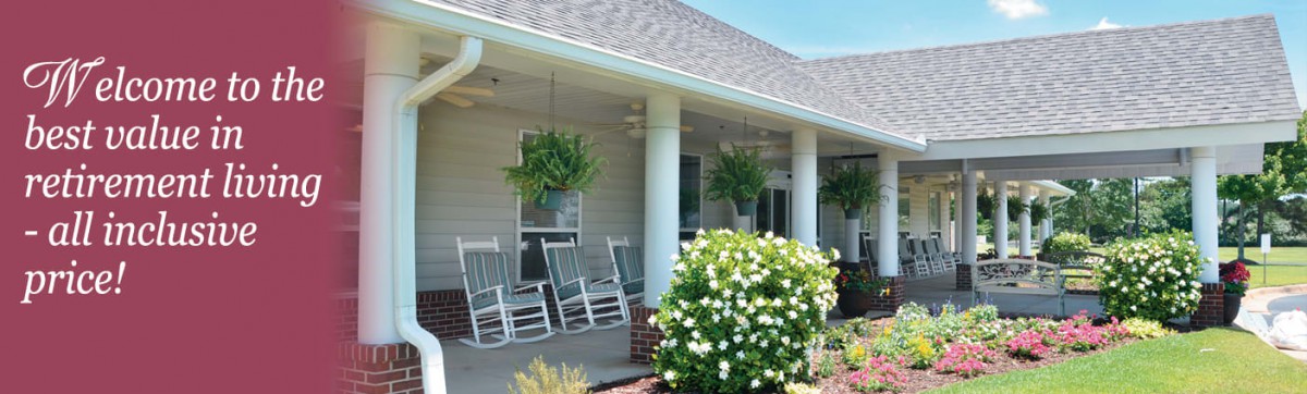 A cozy porch with rocking chairs, hanging plants, and lush greenery.