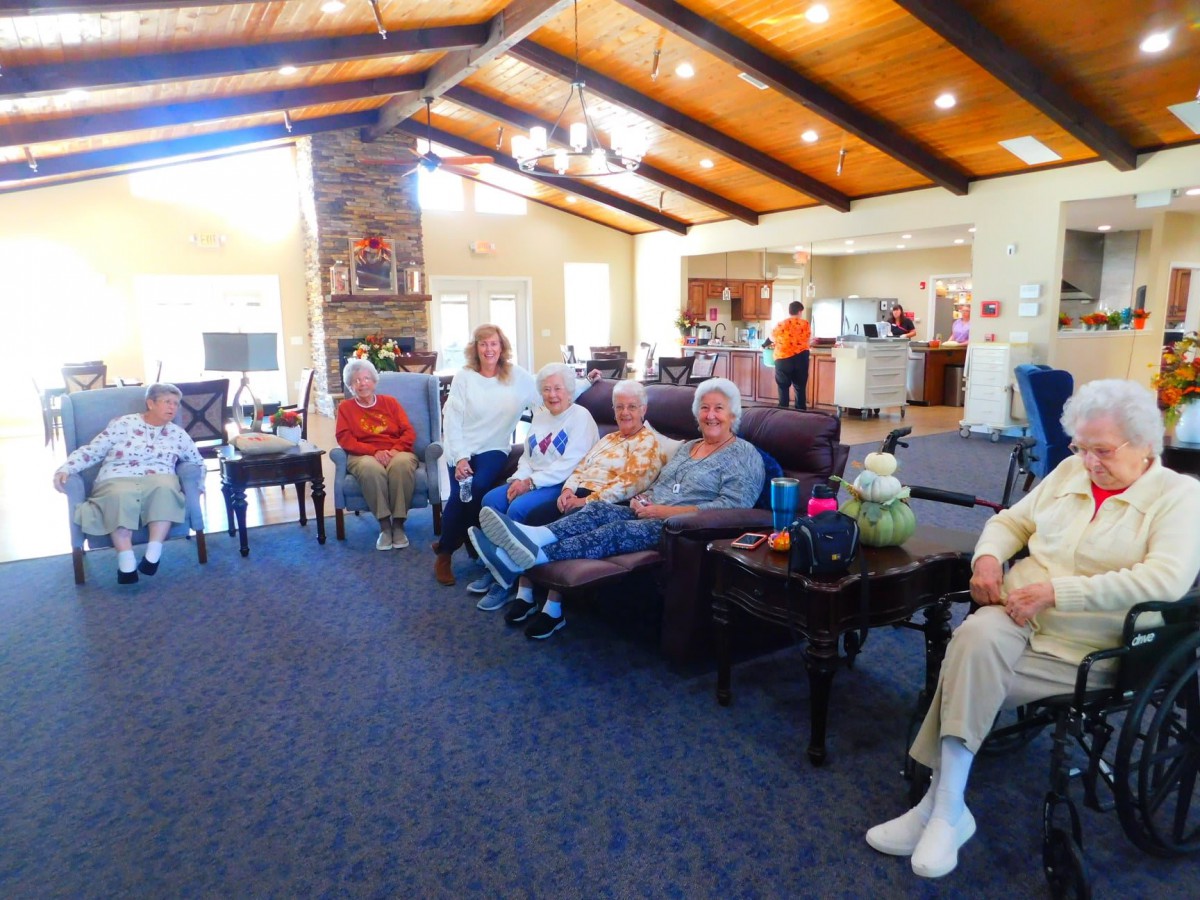 A group of seniors gathered in a cozy living room setting.