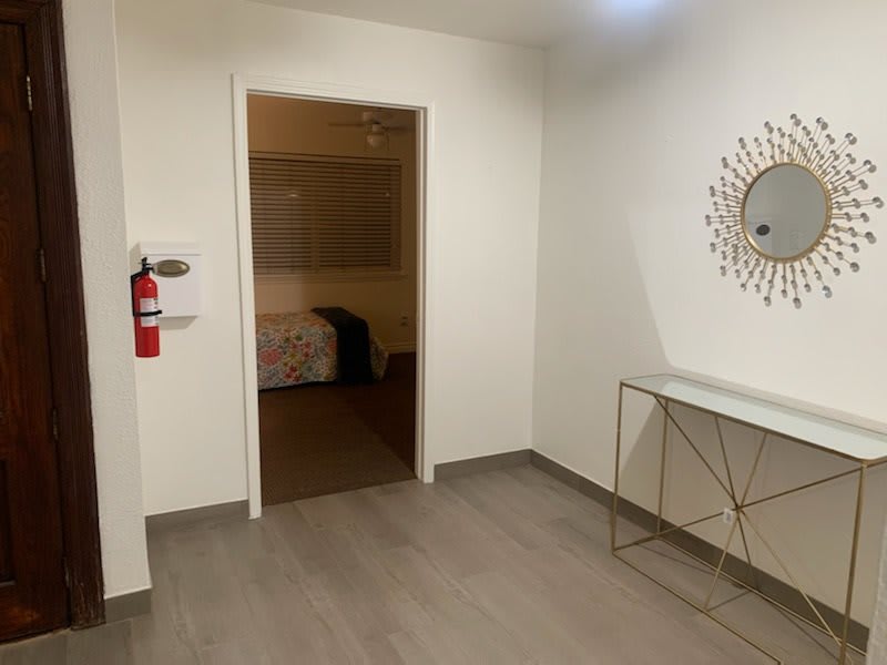 A modern interior with minimalist decor featuring a console table and mirror.