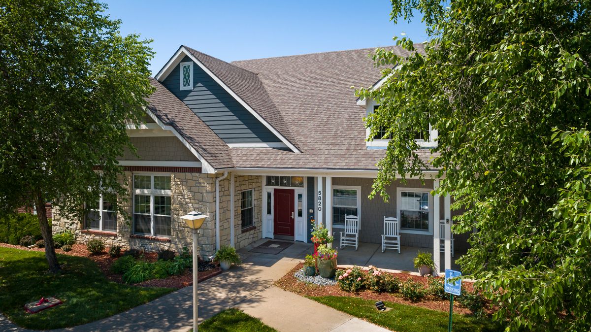 A charming suburban house with a well-maintained garden and inviting front porch.
