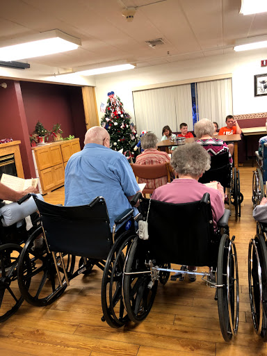 Residents participating in a community activity with holiday decorations in the background.