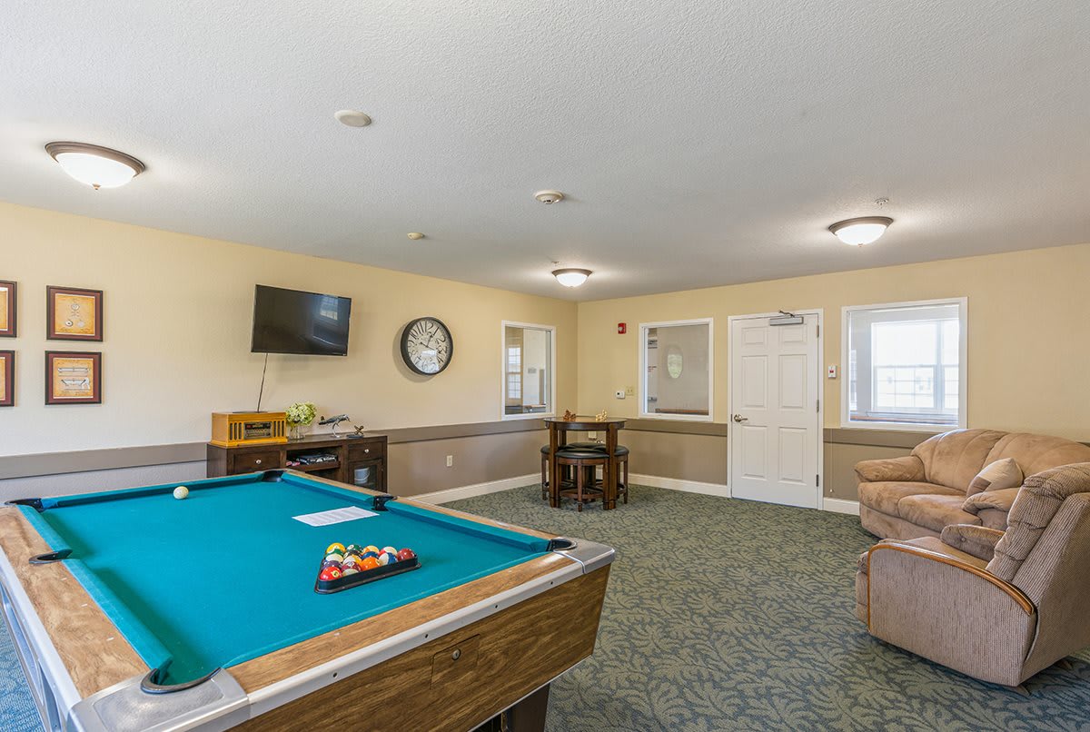 A game room featuring a pool table, television, and seating area.