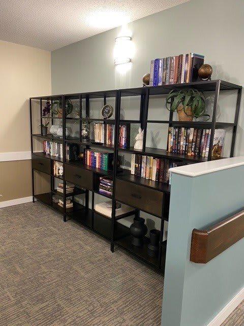 A neatly organized bookshelf filled with books and decorative items in a well-lit room.