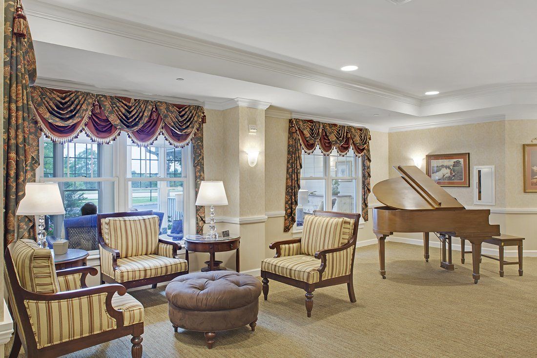 Elegant living room with a grand piano and classic furniture.