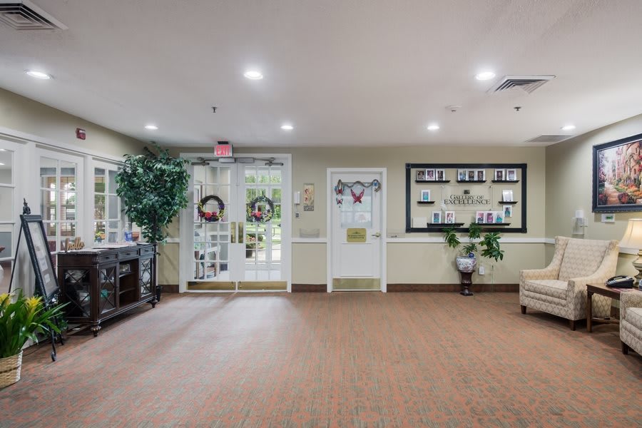A bright and welcoming lobby area with decorations, furniture, and plants.