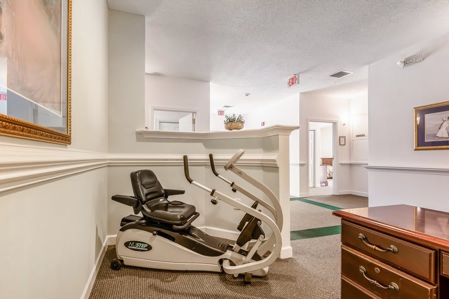 An exercise bike placed in a hallway of an indoor space.