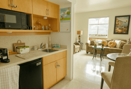 A modern apartment with an open kitchen and a cozy living area.