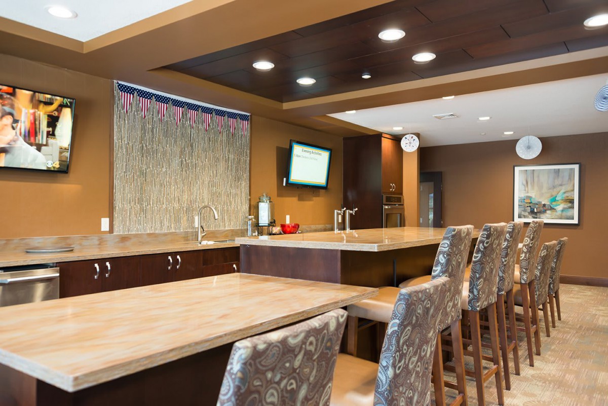 A modern bar area with a large counter and stylish seating.