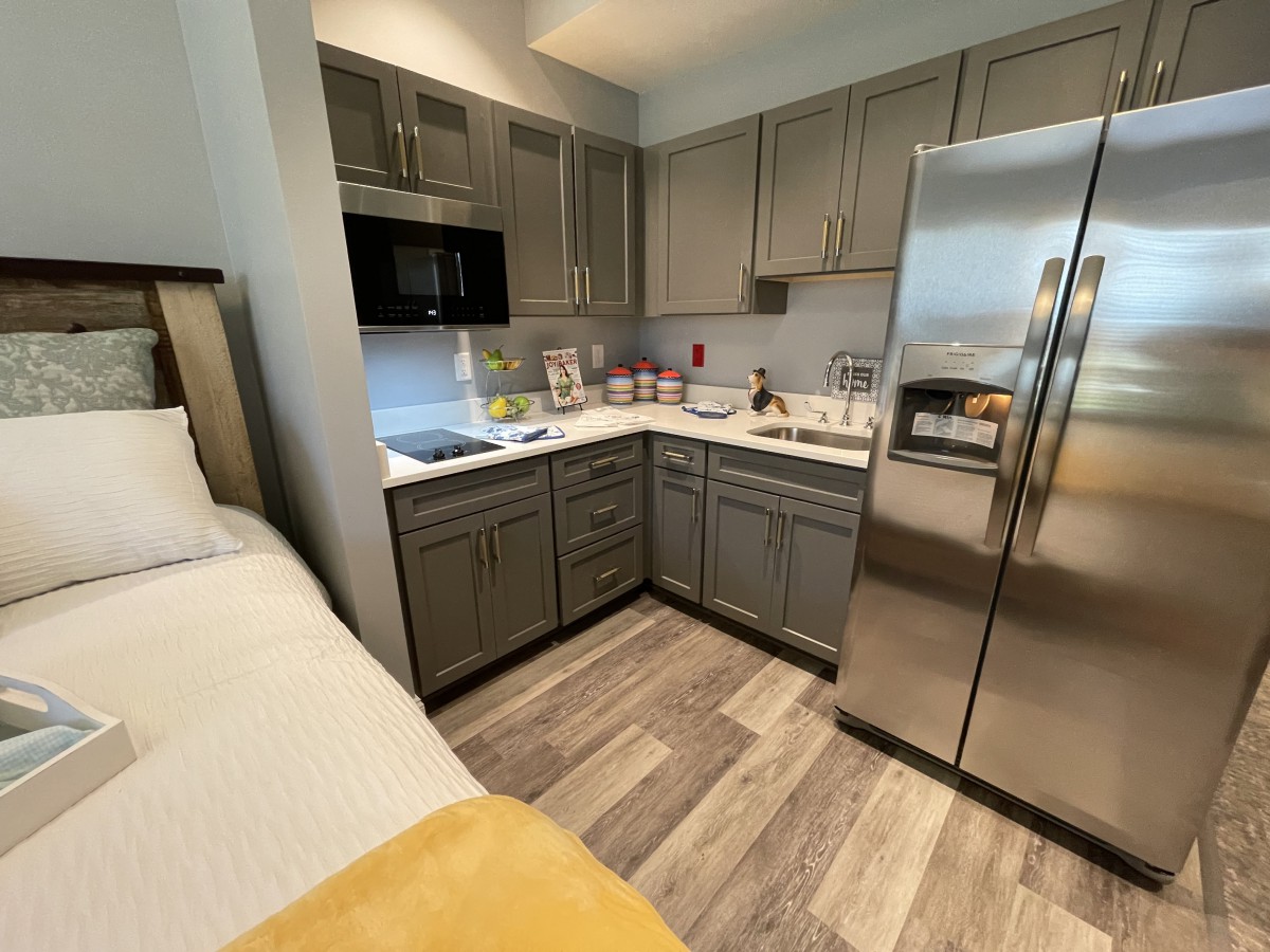 A modern kitchen with stainless steel appliances and wooden cabinets.