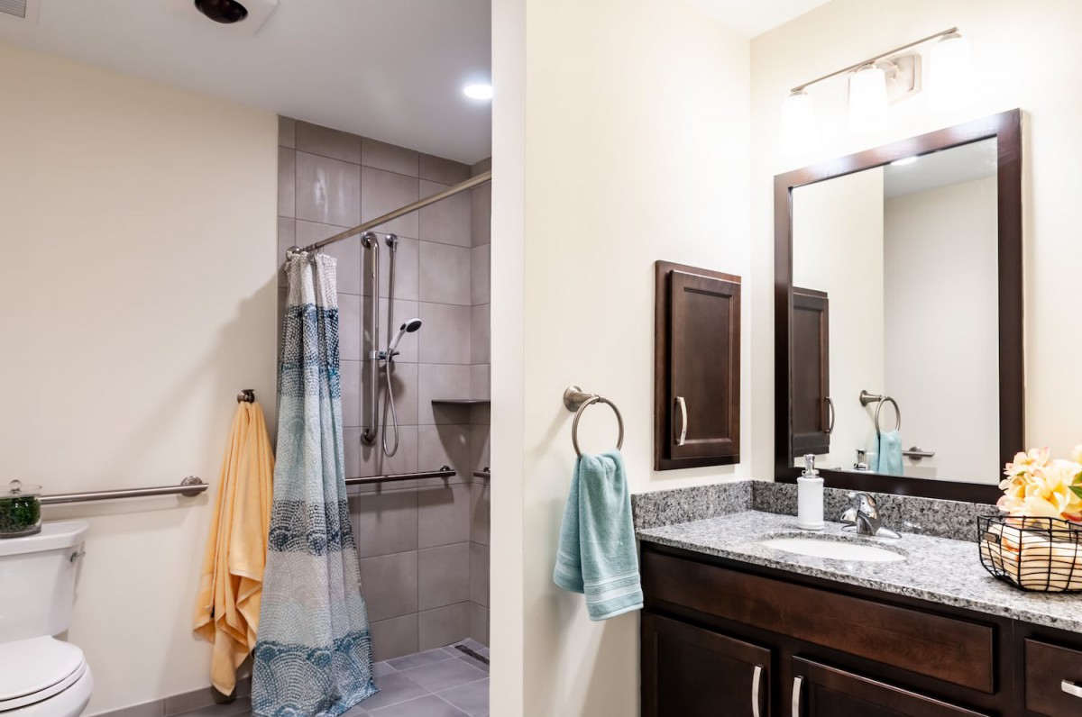 Modern bathroom with a shower, sink, and mirror.