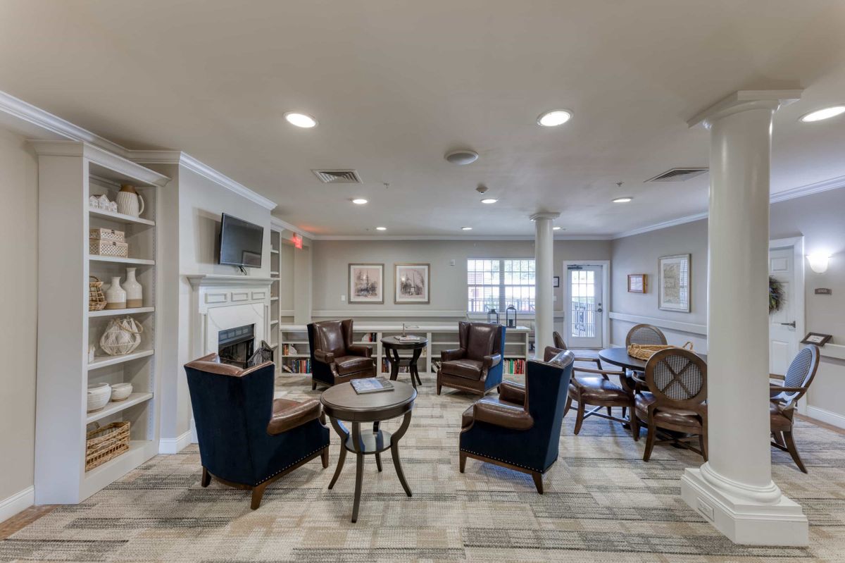 A cozy living room with comfortable seating and a fireplace, designed for relaxation and conversation.
