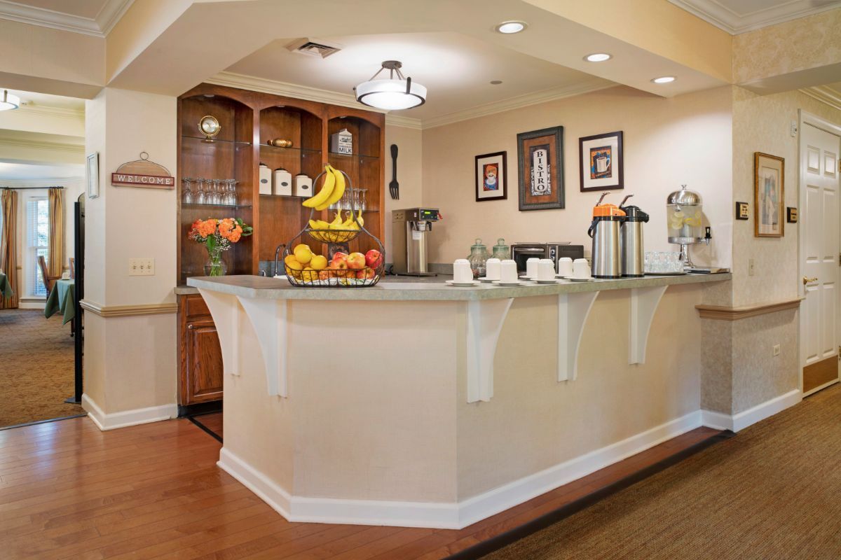 A cozy breakfast bar setup with fruit and drink options.