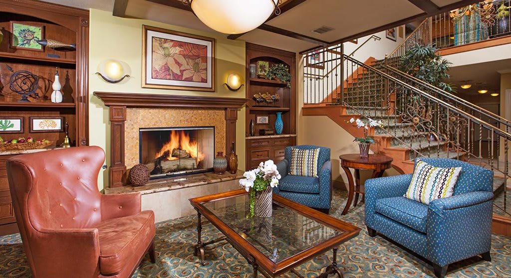 A cozy living room with a warm fireplace and comfortable seating.