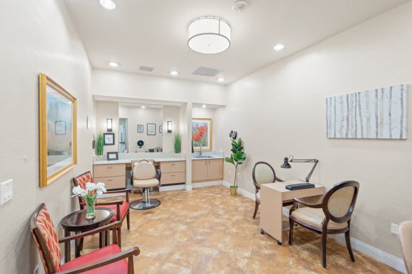 A stylish salon interior with chairs, mirrors, and elegant decor.
