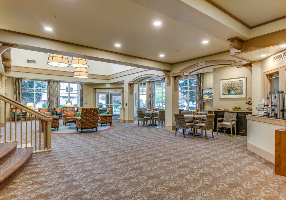 A spacious, well-lit lobby with comfortable seating and large windows.