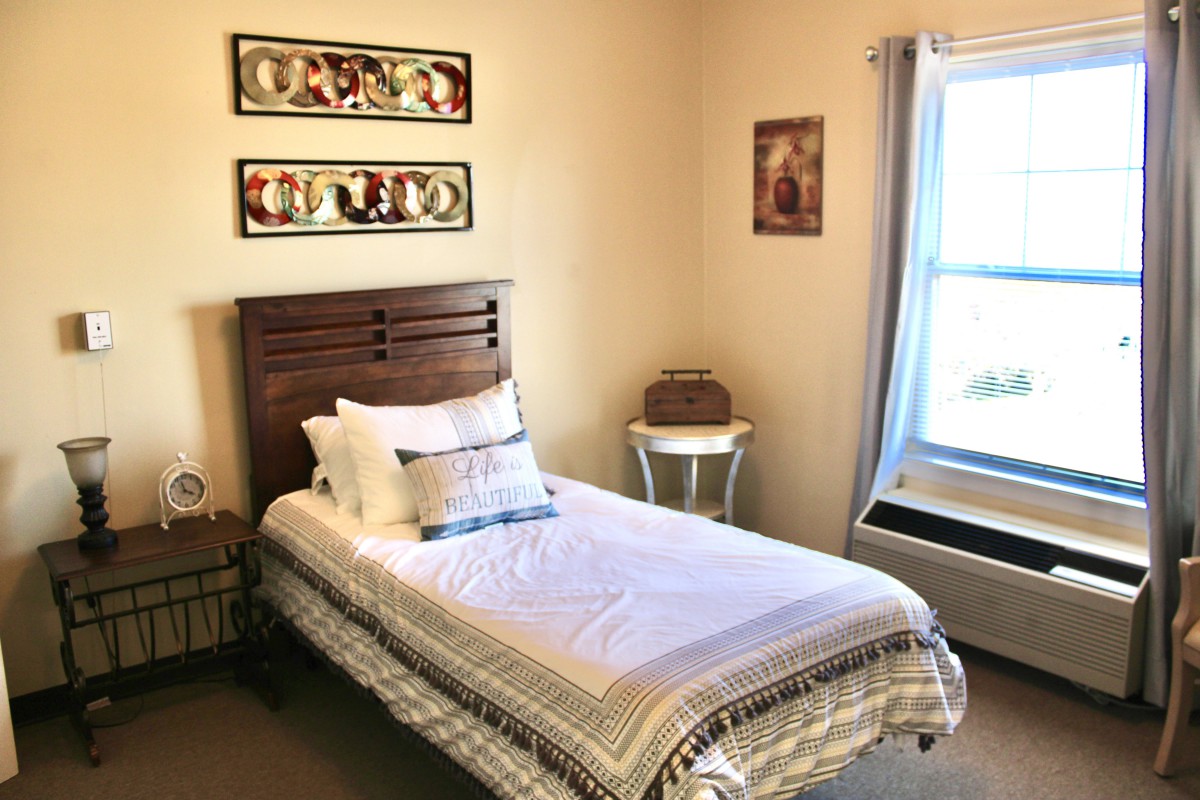 A cozy bedroom with a single bed and decorative wall art.