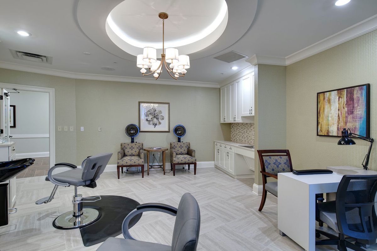 A modern and stylish salon interior with comfortable seating and elegant lighting.