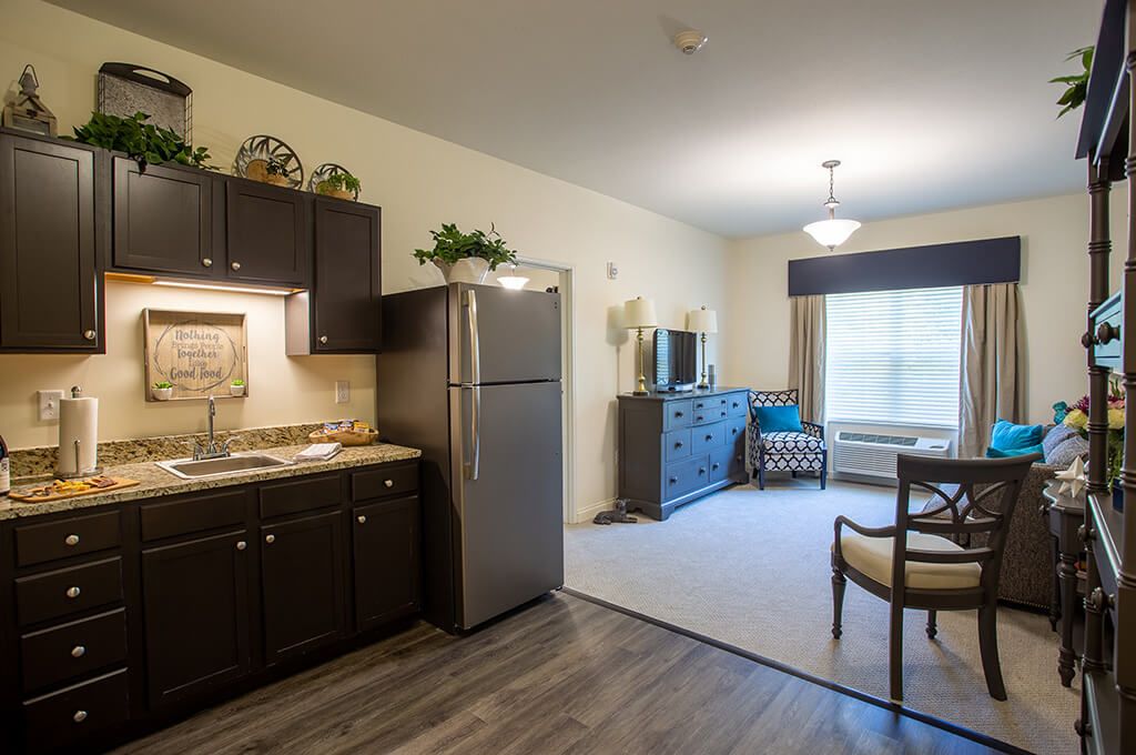 A modern apartment interior featuring a compact kitchen and cozy living area.