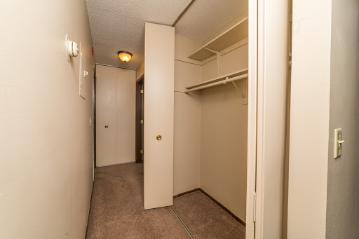 An empty hallway leading to a spacious closet.