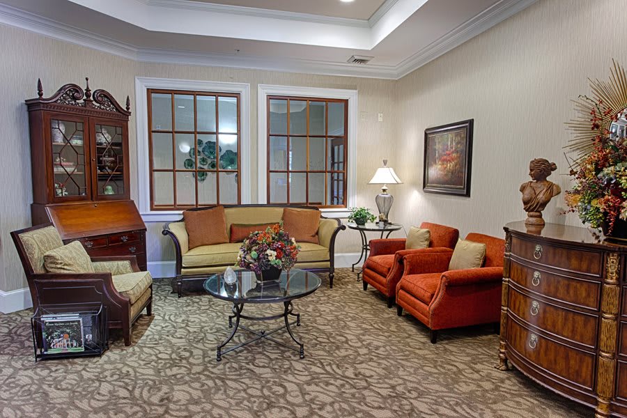 A cozy living room with sofas, chairs, a coffee table, and decorative elements.